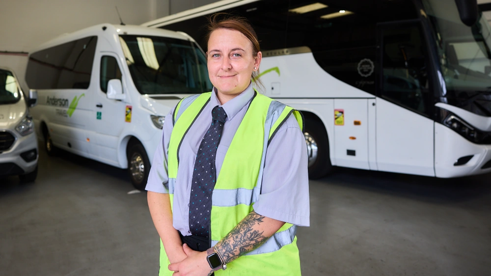 Anderson Travel_Coach Driver Anderson Travel coach driver standing beside the company’s coaches